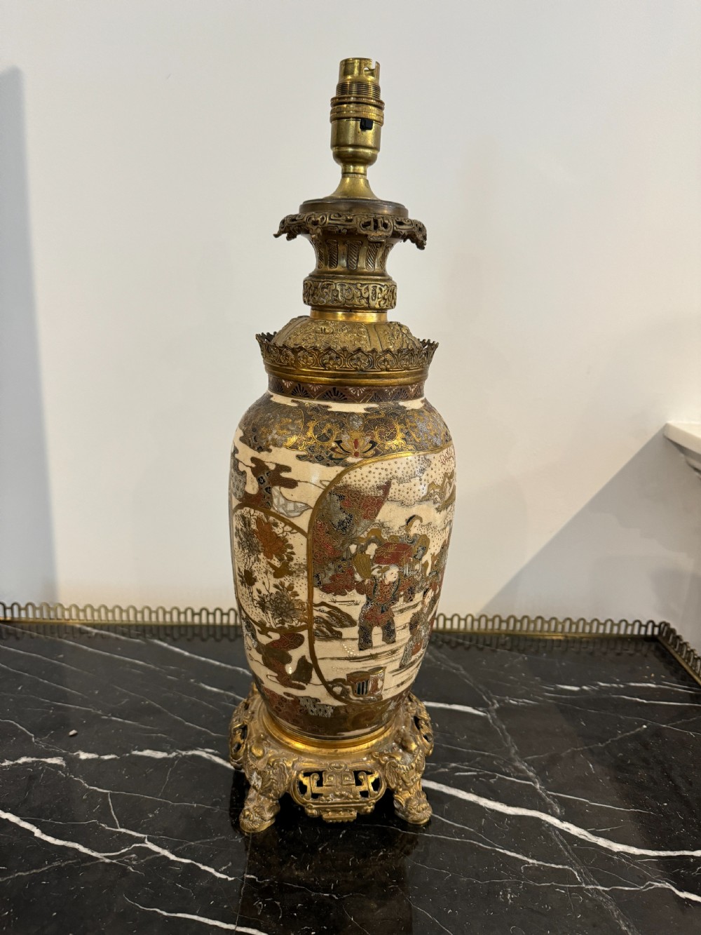 A late 19th-century Japanese Satsuma ceramic vase fitted as a table lamp, featuring detailed figurative enamel paintings and gilded ormolu bases and mounts.
