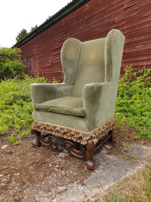 Upholstered Wing Back Armchair of Queen Anne Design.