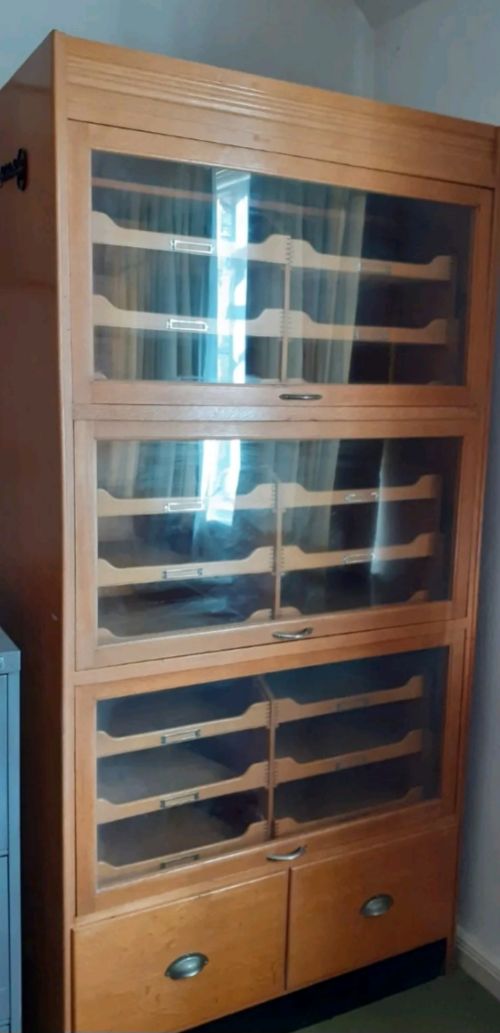 Oak haberdashery cabinet with sliding trays.
