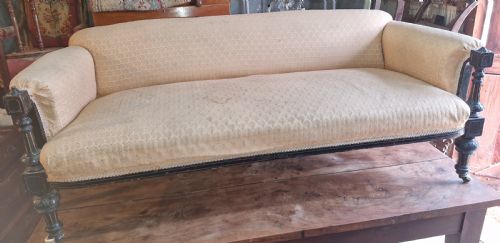 Late Victorian Ebonised Framed Upholstered Sofa .