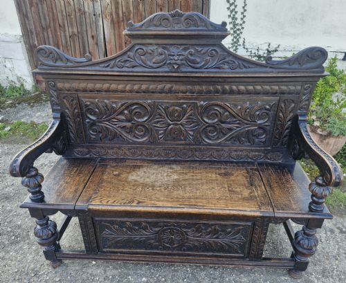 LATE VICTORIAN CARVED OAK HALL BENCH