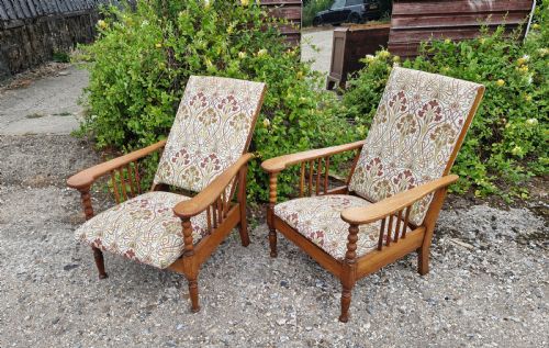 PAIR OF LIGHT OAK ARTS AND CRAFTS RECLINING ARMCHAIRS STAMPED