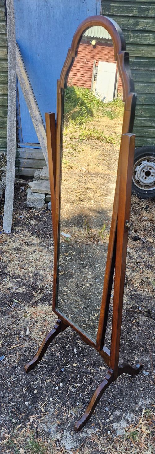 A full-length walnut cheval mirror featuring an arched wooden frame suspended between two vertical uprights on splayed feet. View V