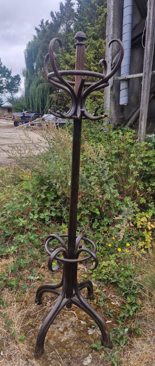 An early 20th-century dark brown steam-bent beechwood freestanding hat and coat stand featuring curved upper hooks and an integrated lower umbrella ring. View III