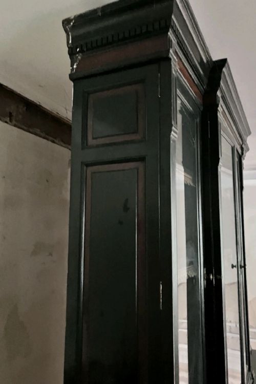 A large Victorian ebonised and mahogany breakfront library bookcase featuring glazed upper doors, panelled lower cupboards, and fluted side pilasters. View VII