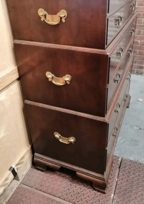 A three-part mahogany campaign style chest of drawers featuring brass handles, side carrying brackets, and bracket feet. View II