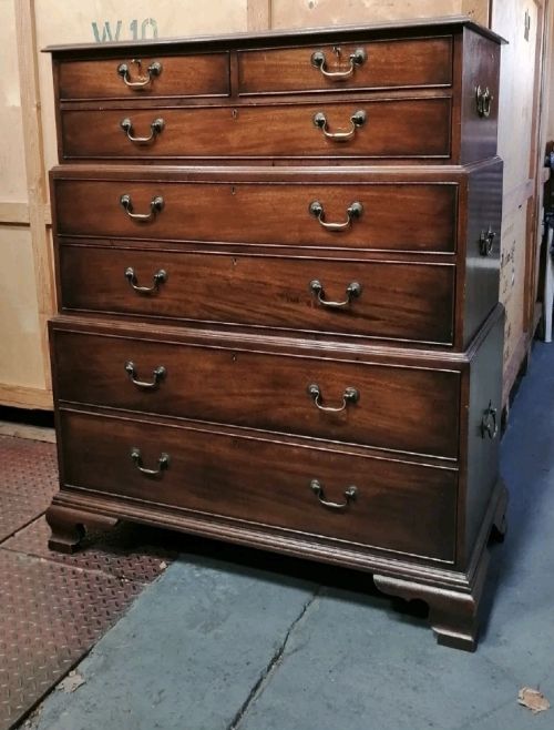 A three-part mahogany campaign style chest of drawers featuring brass handles, side carrying brackets, and bracket feet. View III