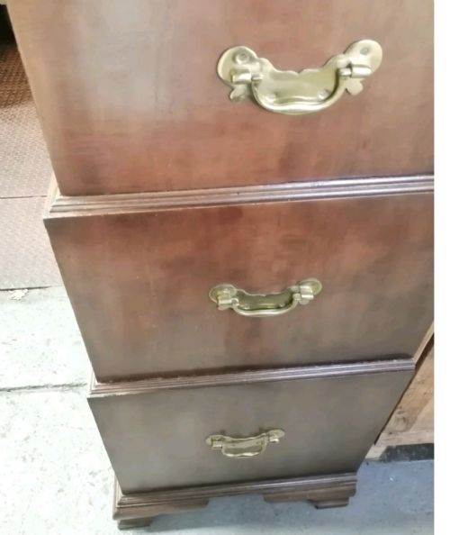 A three-part mahogany campaign style chest of drawers featuring brass handles, side carrying brackets, and bracket feet. View VI