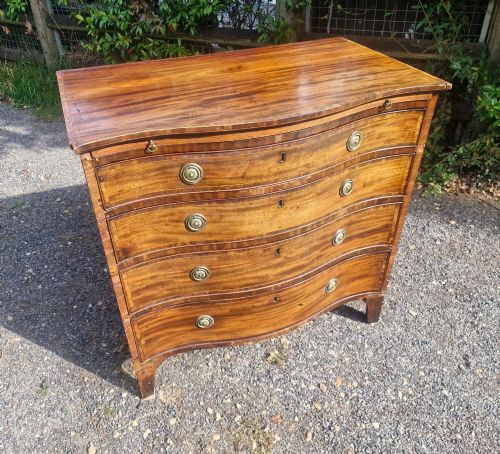 Inlaid Mahogany Serpentine Front Chest of Drawers with Brushing Slide.