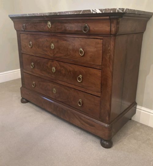 A nineteenth-century French mahogany chest of drawers featuring four drawers with brass ring pulls, escutcheons, and a grey veined marble top. View VII