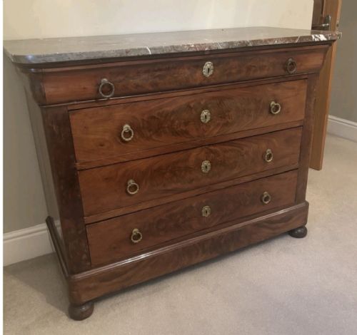 A nineteenth-century French mahogany chest of drawers featuring four drawers with brass ring pulls, escutcheons, and a grey veined marble top. View VIII