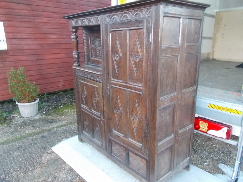 Antique carved oak hall cupboard