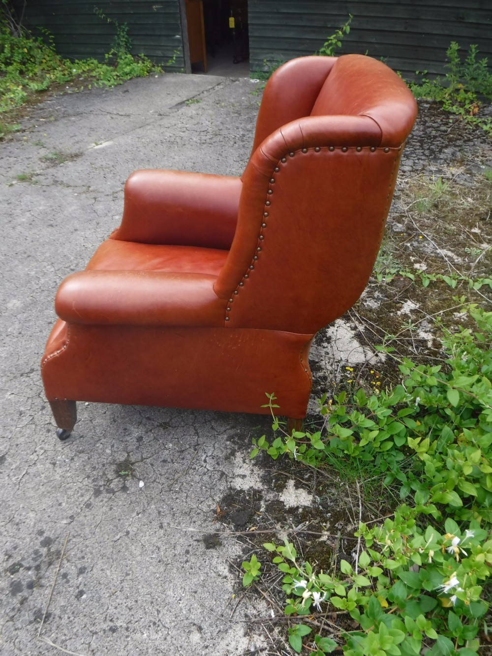 Early 20th century leather shaped and wing back armchair View IV