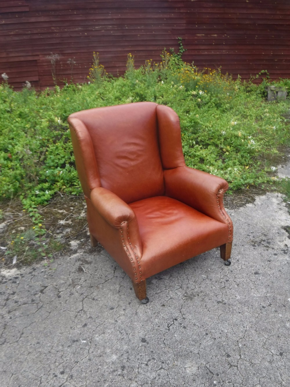 Early 20th century leather shaped and wing back armchair View V