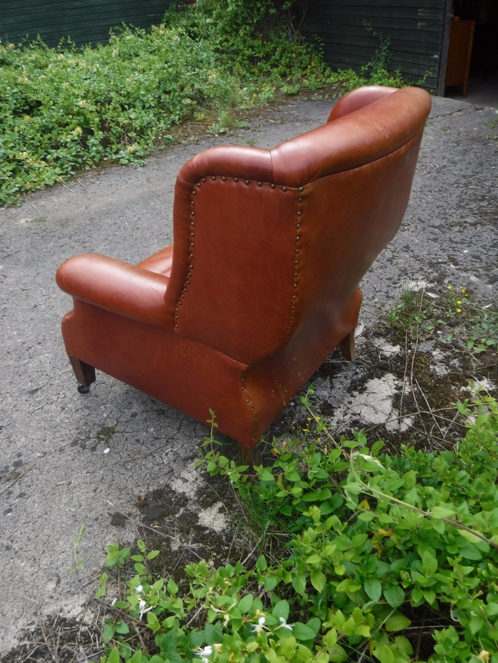 Early 20th century leather shaped and wing back armchair View VI