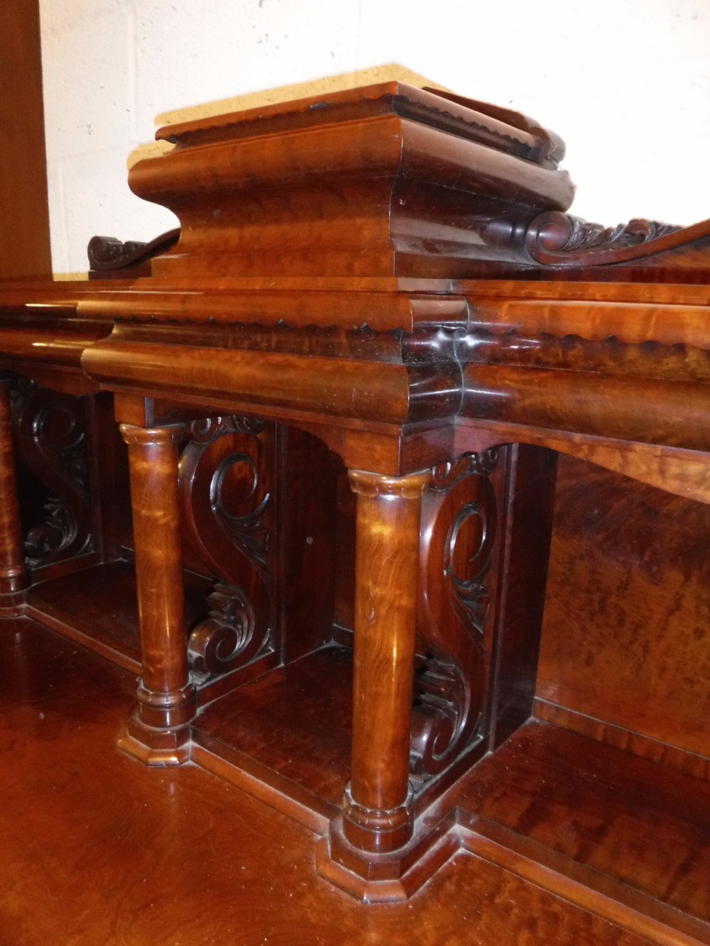 A large Regency mahogany side cabinet featuring turned support columns, panelled cupboard doors, and a tier of raised shelves. View XIII