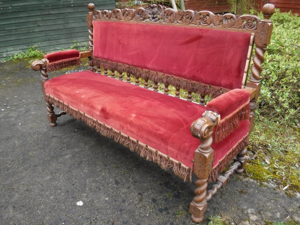 A late nineteenth-century carved oak hall bench featuring red velvet upholstery with fringe trim and barley twist legs. View III