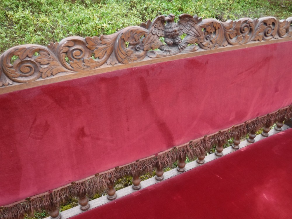 A late nineteenth-century carved oak hall bench featuring red velvet upholstery with fringe trim and barley twist legs. View VIII
