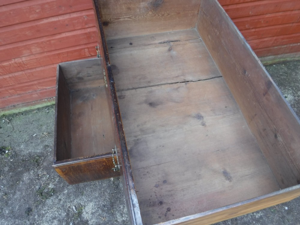 An early eighteenth-century oak chest on stand featuring crossbanded drawer fronts, brass drop handles, keyhole escutcheons, a shaped apron, and cabriole legs with pad feet. View IX