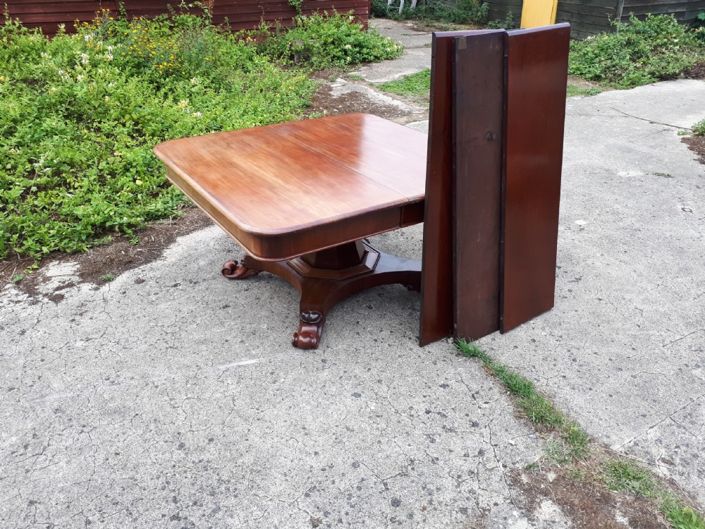 Unusual Regency mahogany central pillar extending dining table. View II
