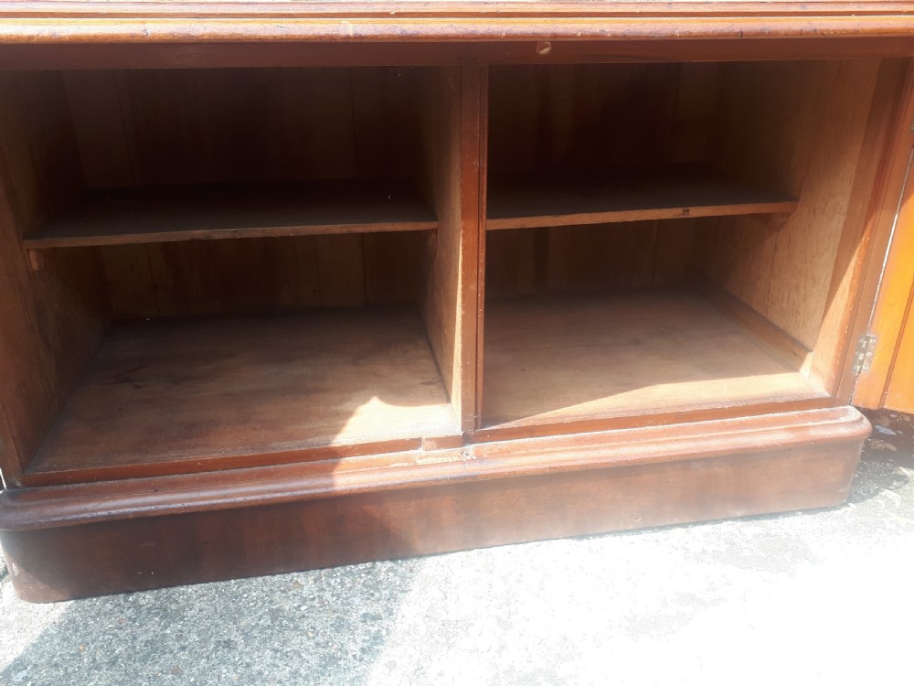 A 19th-century Victorian mahogany side cabinet featuring a two-door base cupboard, open display tier with scroll supports, and a carved gallery back. View VI