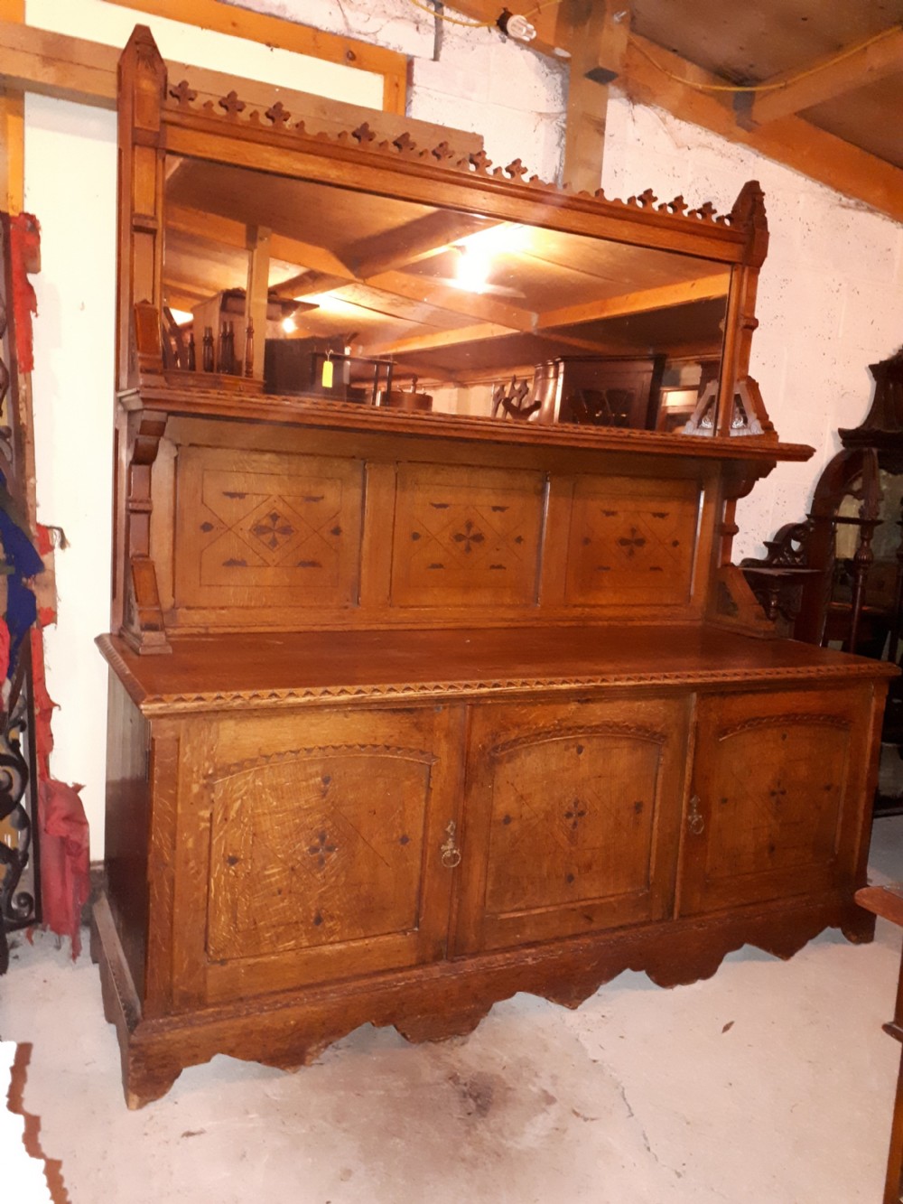 Useful 19th century oak gothic mirror back side cabinet