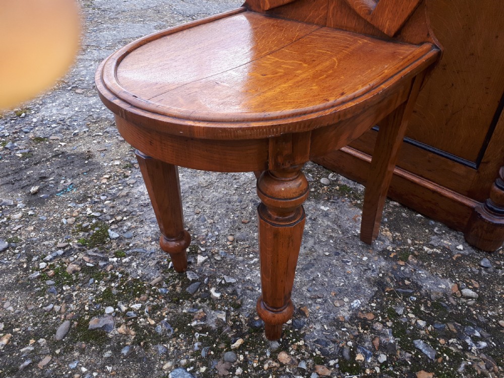 Unusual Mid 19th century oak horse shoe back hall chair. View IV