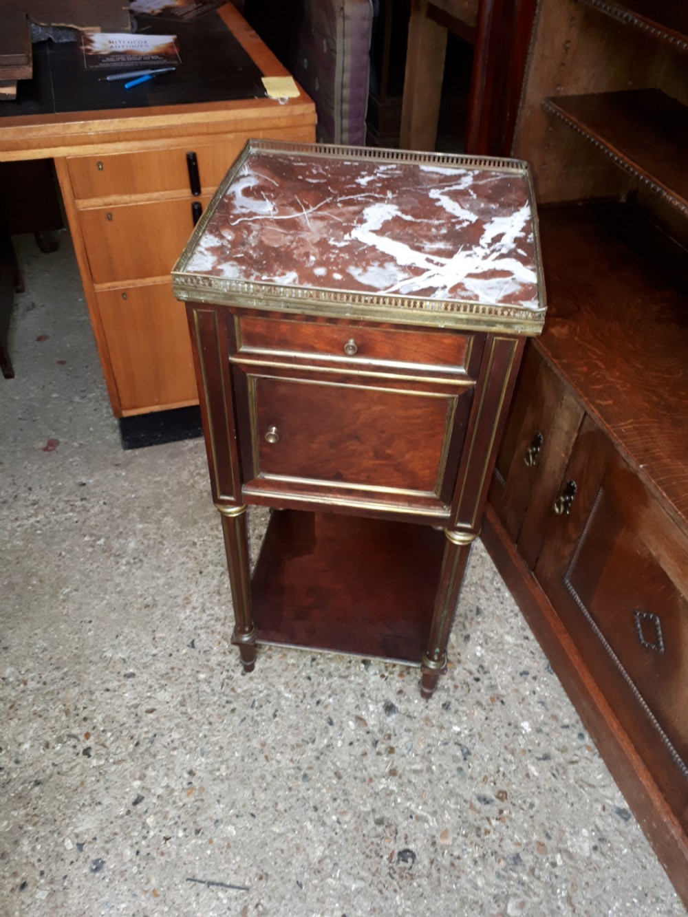 A 19th-century mahogany bedside cabinet featuring a red veined marble top with a brass gallery, a single drawer, a cupboard door, brass inlay trim, and fluted legs with an open lower shelf. View II