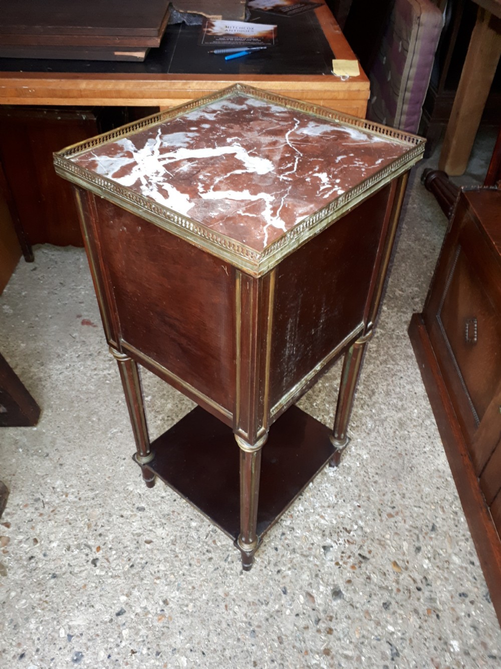 A 19th-century mahogany bedside cabinet featuring a red veined marble top with a brass gallery, a single drawer, a cupboard door, brass inlay trim, and fluted legs with an open lower shelf. View III