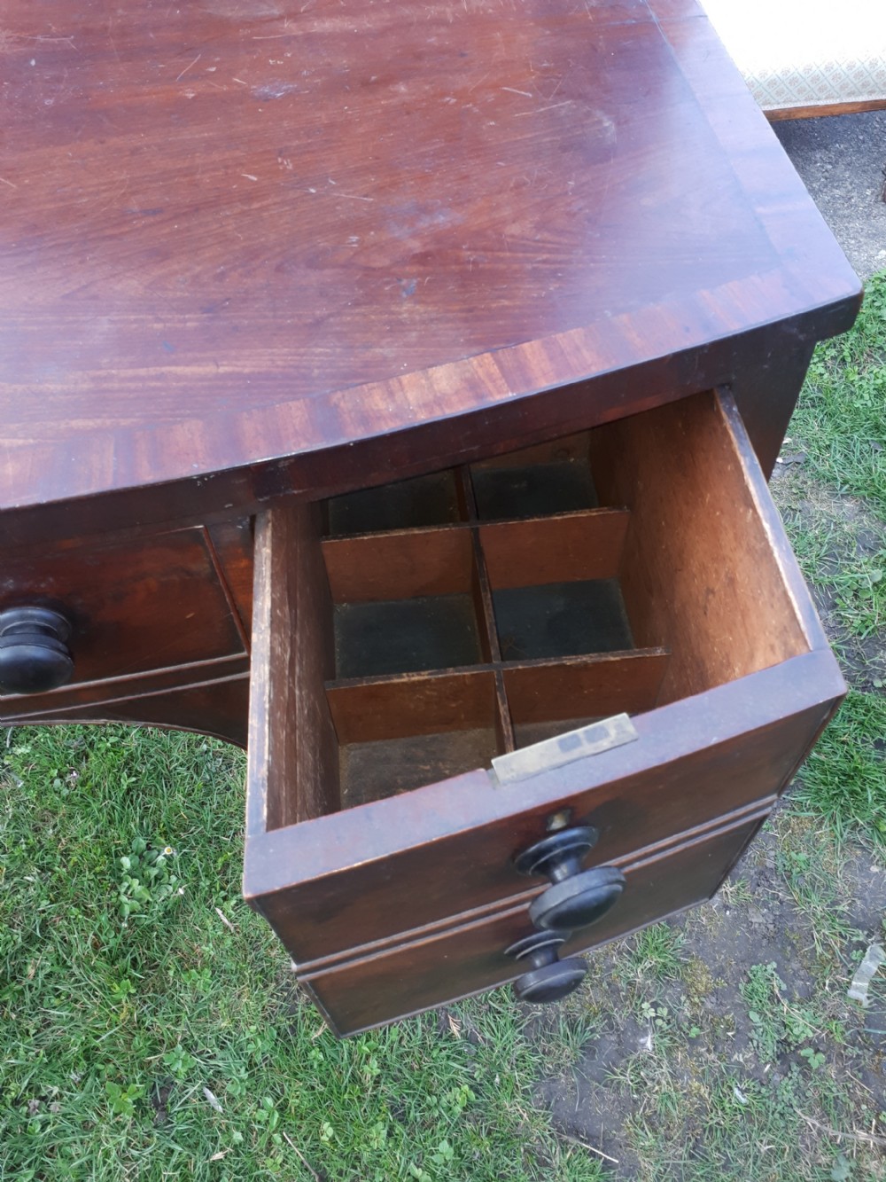 A nineteenth-century Regency mahogany bow-fronted sideboard featuring five drawers with turned wooden knobs and four turned legs. View III