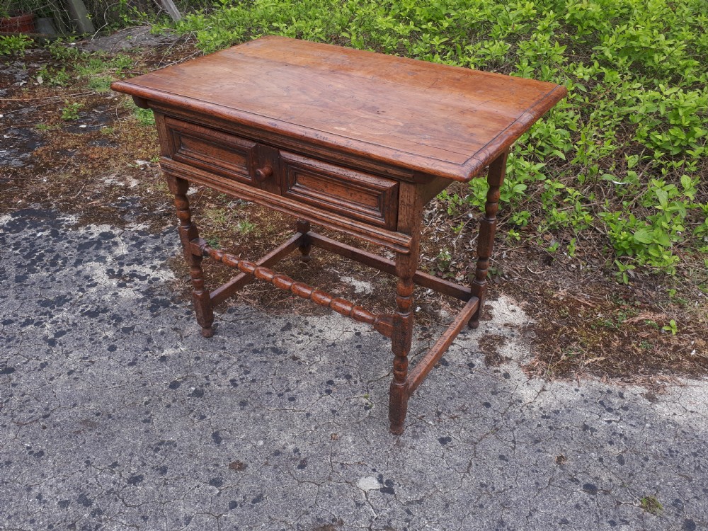 An antique oak side table featuring a single moulded drawer, turned legs, and lower stretchers. View III