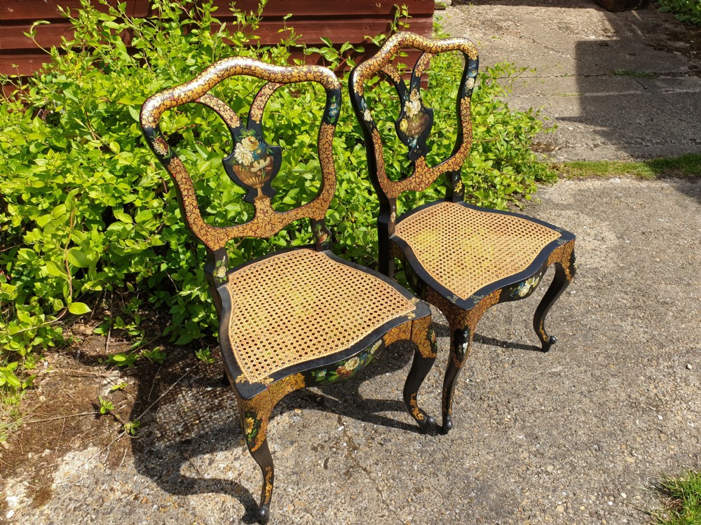 Lovely pair of lacquered and painted cane seat chairs.