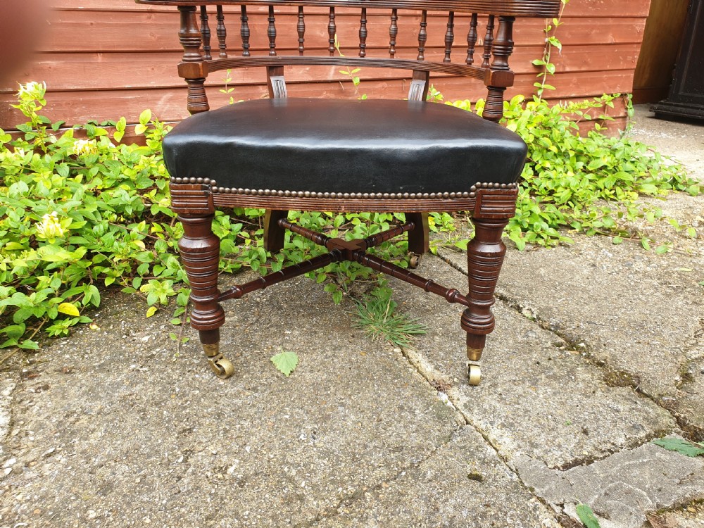 Late Victorian mahogany desk armchair with makers stamp.  View IV