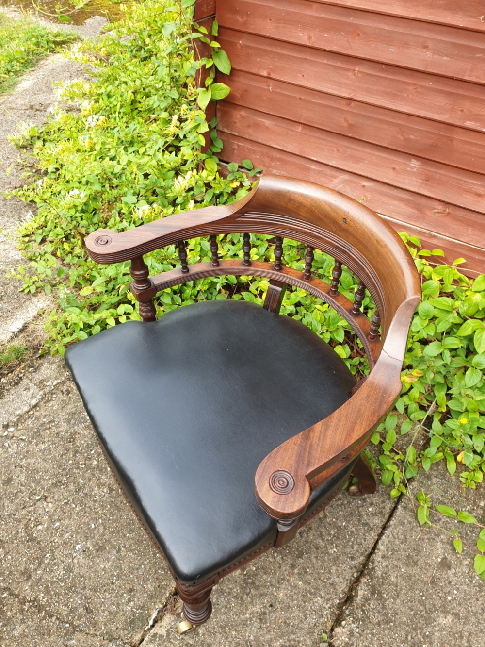 Late Victorian mahogany desk armchair with makers stamp.  View V