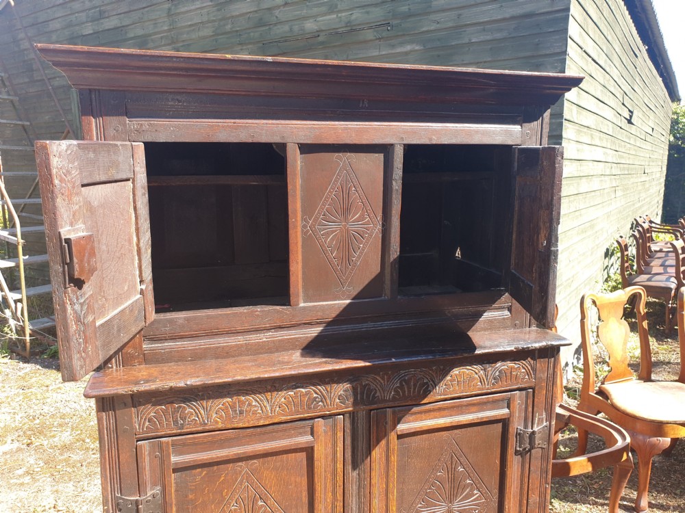 Neat and useful antique carved oak hall cupboard . View IV