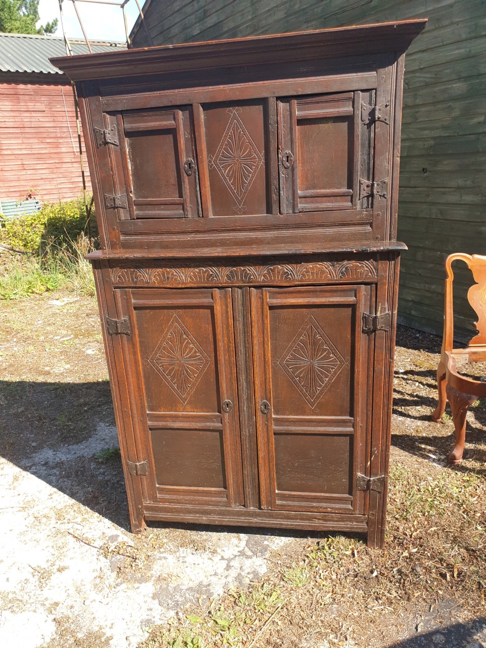 Neat and useful antique carved oak hall cupboard . View VII