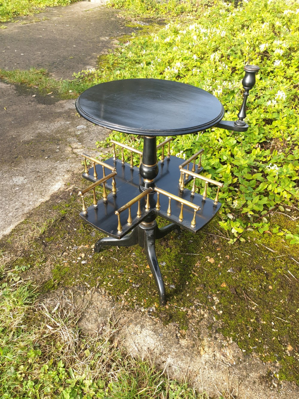 Late Victorian ebonised and gilt revolving occasional table View II