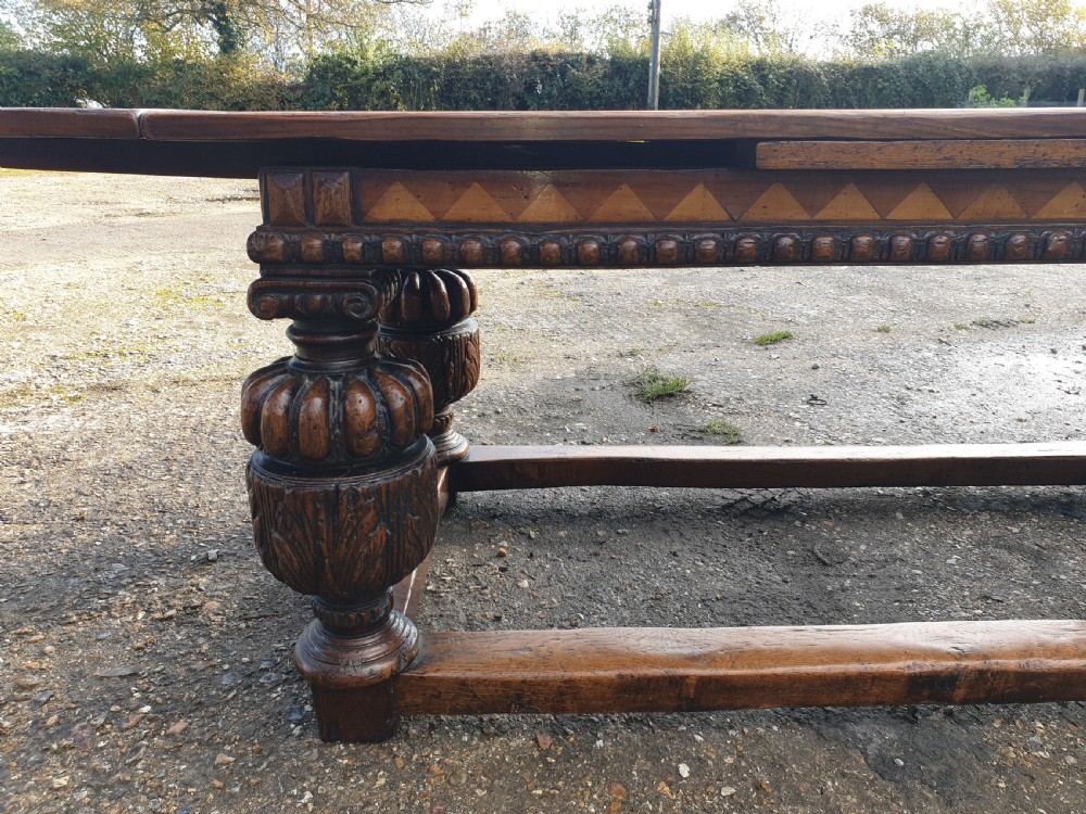 Large carved oak draw leaf refectory dining table.  View II