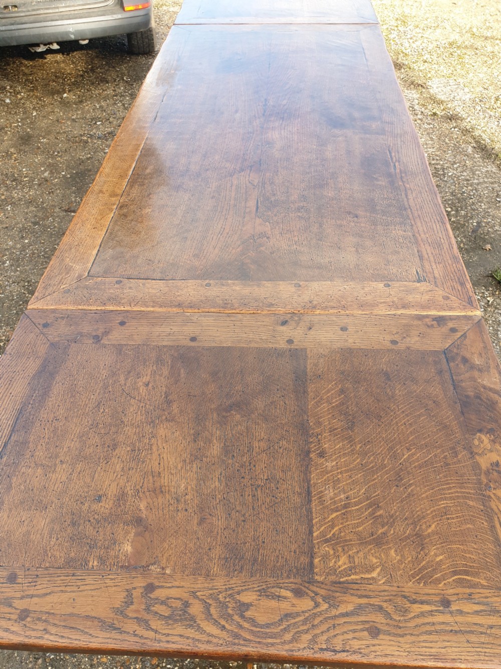 Large carved oak draw leaf refectory dining table.  View III