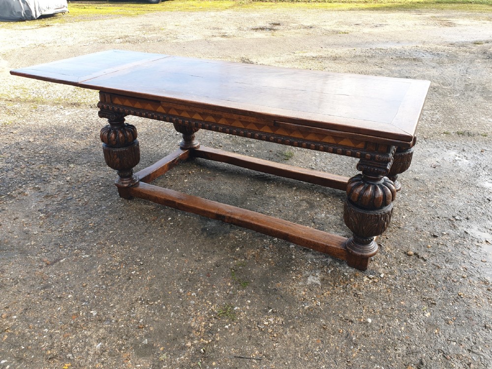 Large carved oak draw leaf refectory dining table.  View VI