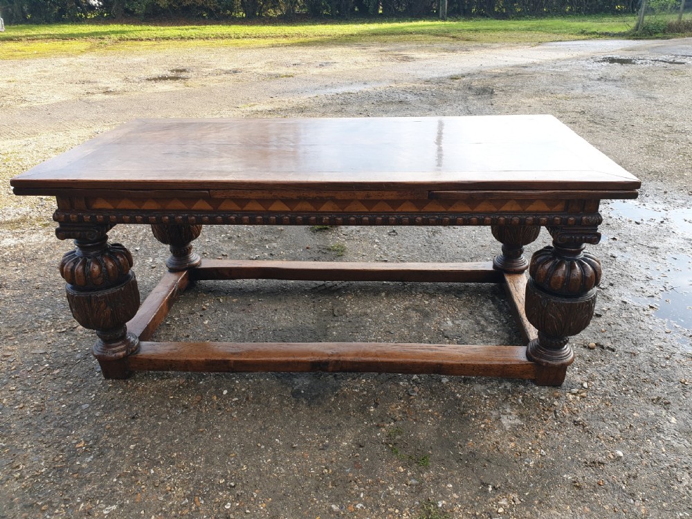 Large carved oak draw leaf refectory dining table.  View VII