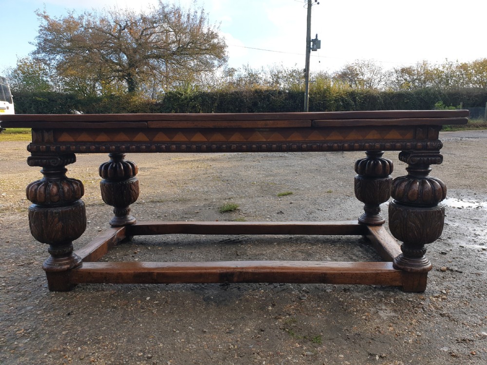Large carved oak draw leaf refectory dining table.  View VIII