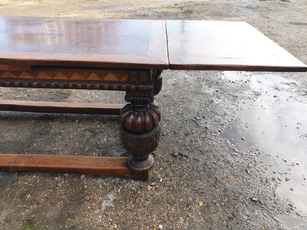 Large carved oak draw leaf refectory dining table.  View IX