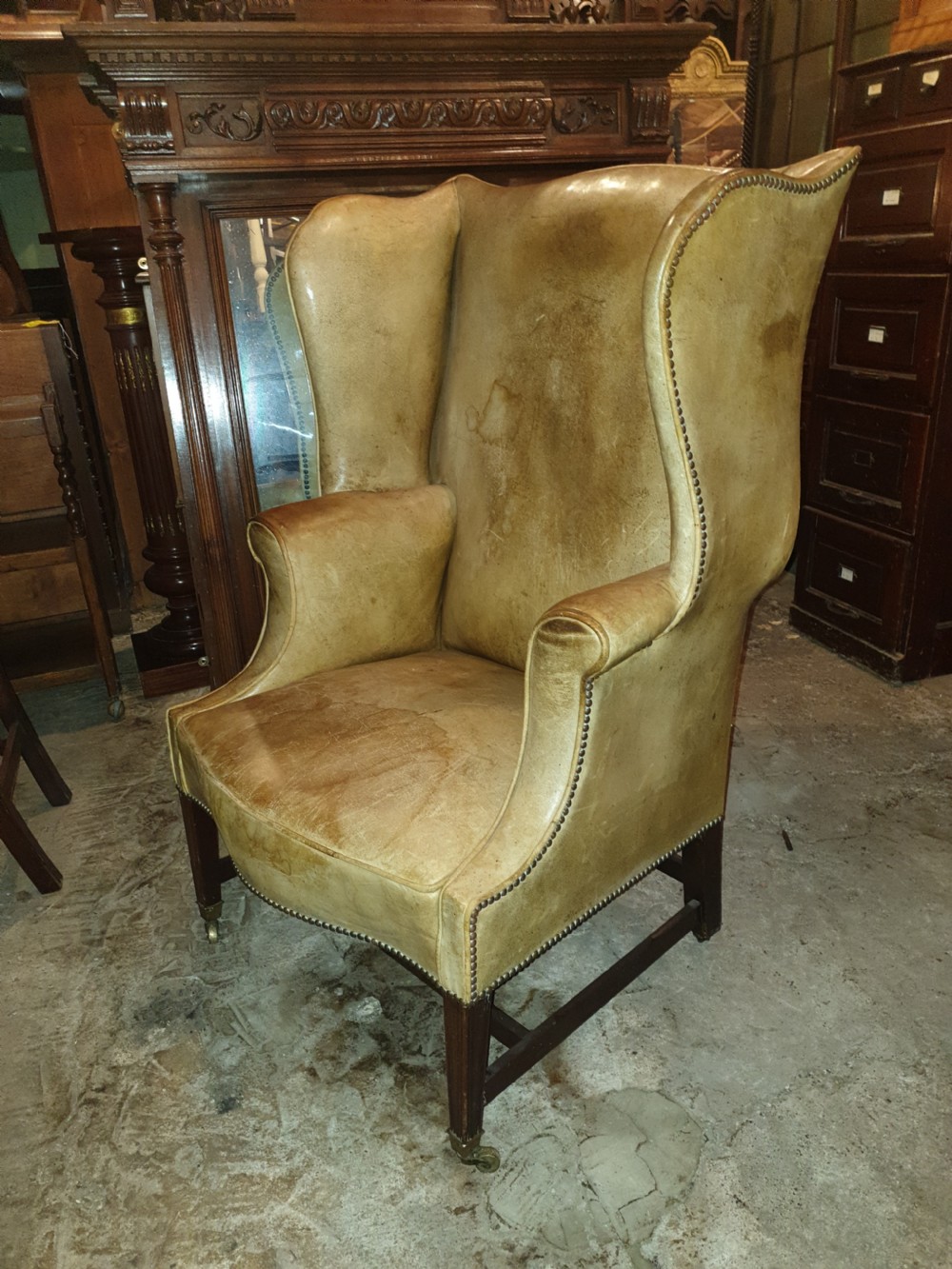 Good shaped leather wing back armchair  View III
