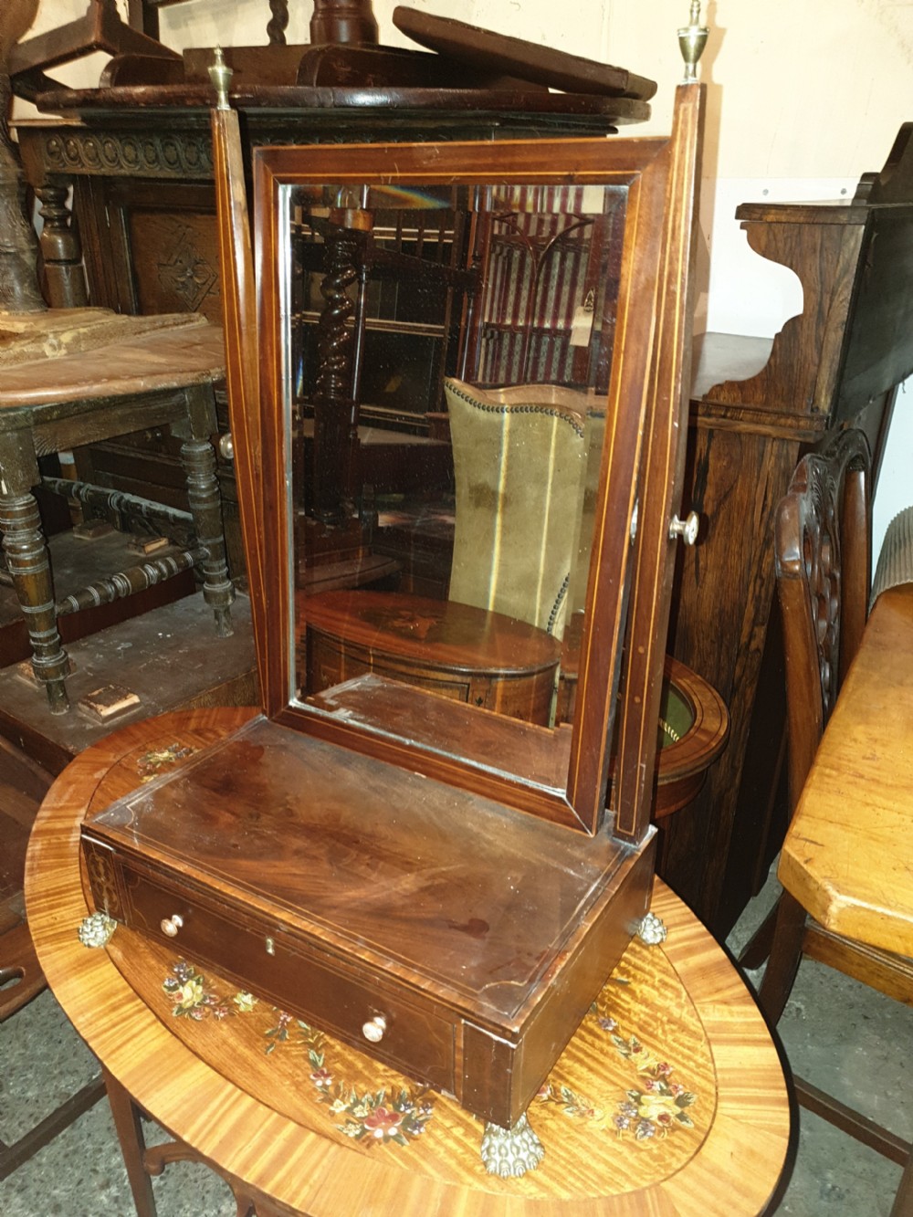 Inlaid dressing table mirror with brass feet.
