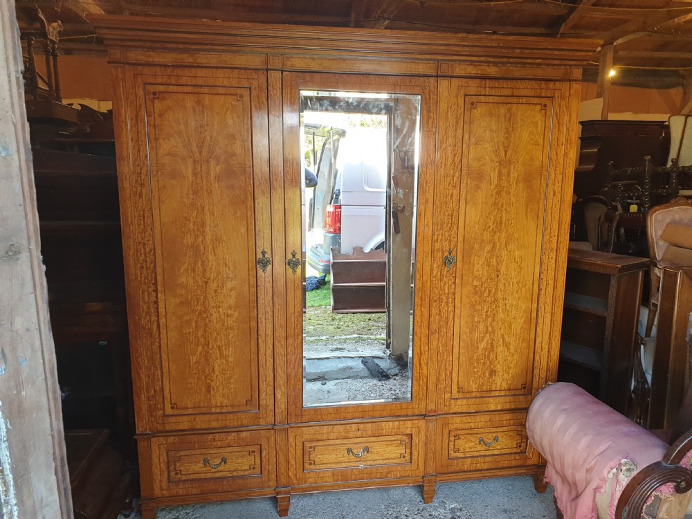 Good quality late Victorian satinwood triple wardrobe. 