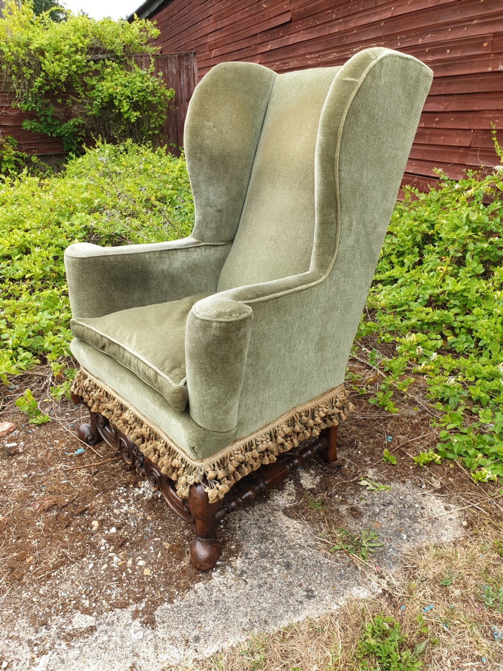 Upholstered wing back armchair of Queen Anne design.  View II