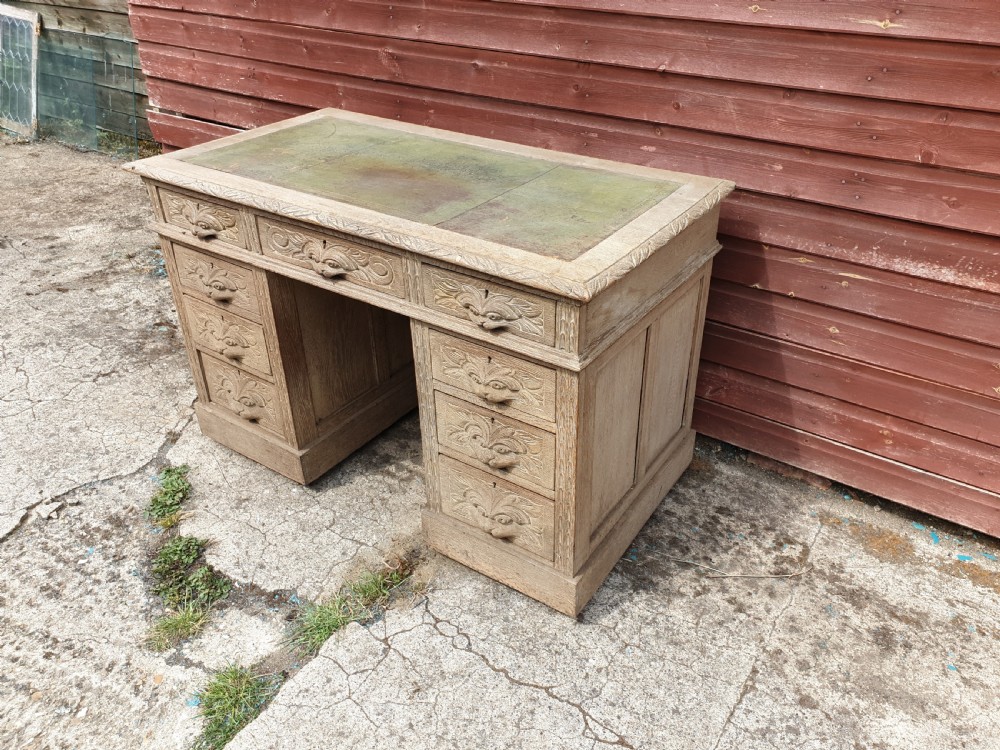 Early 20th century carved oak kneehole pedestal desk 