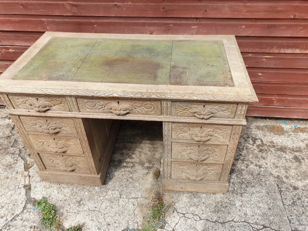 Early 20th century carved oak kneehole pedestal desk  View II