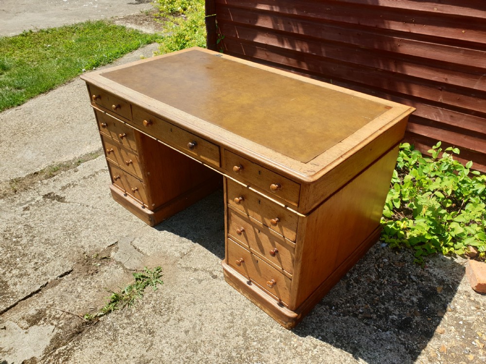 Late Victorian oak kneehole pedestal desk of good size. View II